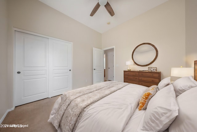 carpeted bedroom featuring lofted ceiling, ceiling fan, and a closet