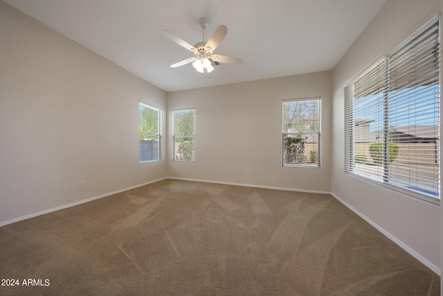 carpeted spare room with ceiling fan