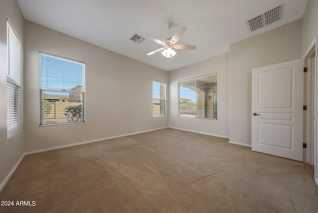 empty room with light carpet and ceiling fan