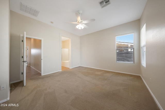 carpeted empty room featuring ceiling fan