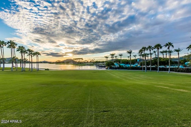 view of home's community featuring a water view and a lawn