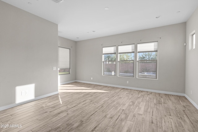 unfurnished room with light wood-type flooring