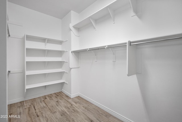 walk in closet featuring light hardwood / wood-style floors