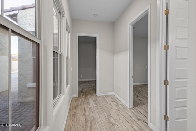 corridor with light wood-type flooring