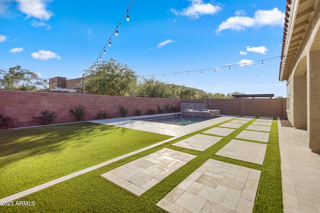 view of yard featuring a swimming pool with hot tub and a patio area