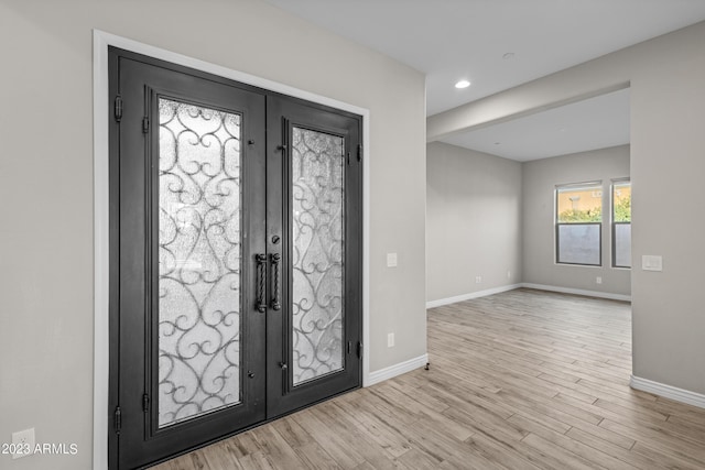 entryway with french doors and light wood-type flooring