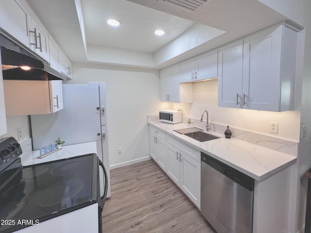 kitchen featuring a raised ceiling, stainless steel dishwasher, white cabinetry, a sink, and black range with electric cooktop