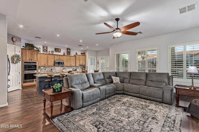 2045 E San Carlos Pl, Chandler, AZ 85249 - living area featuring a ceiling fan, dark wood-style floors, plenty of natural light, and recessed lighting