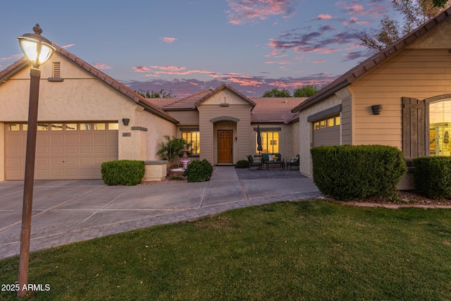 2045 E San Carlos Pl, Chandler, AZ 85249 - view of front of property with a garage, a front yard, concrete driveway, stucco siding, and a tile roof
