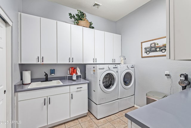 2045 E San Carlos Pl, Chandler, AZ 85249 - laundry room featuring cabinet space, washing machine and dryer, and light tile patterned flooring