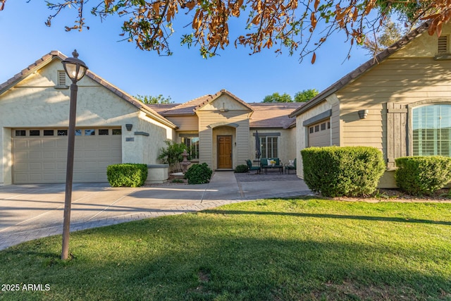 2045 E San Carlos Pl, Chandler, AZ 85249 - view of front of home featuring an attached garage, a front lawn, a tile roof, driveway, and stucco siding