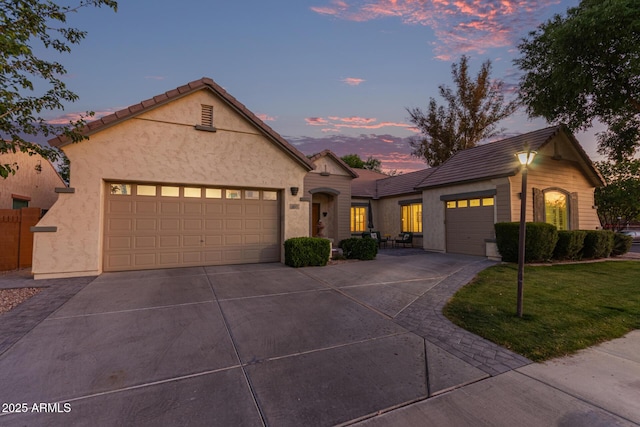 2045 E San Carlos Pl, Chandler, AZ 85249 - ranch-style house with concrete driveway, a garage, stucco siding, and a tile roof