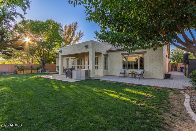 2045 E San Carlos Pl, Chandler, AZ 85249 - rear view of house featuring a patio area, stucco siding, ceiling fan, and a jacuzzi
