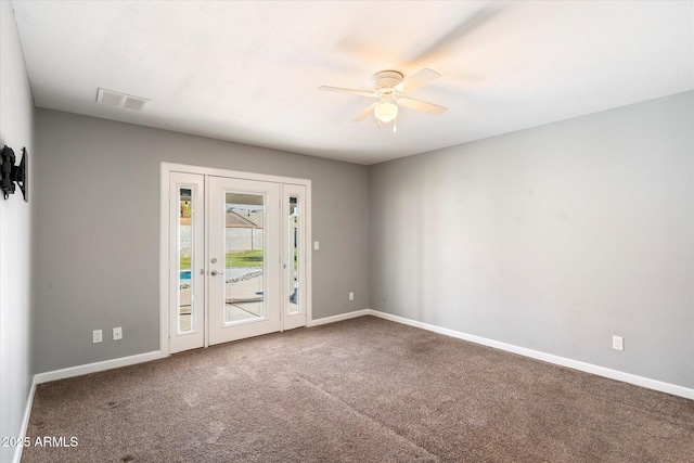 carpeted spare room with ceiling fan