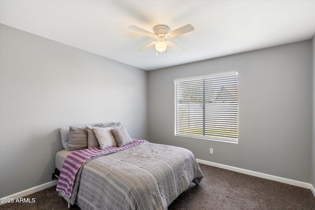 bedroom featuring ceiling fan and dark carpet