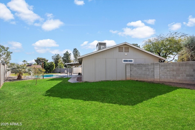 view of yard with a fenced in pool and central air condition unit