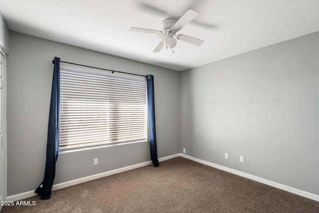 carpeted spare room featuring ceiling fan