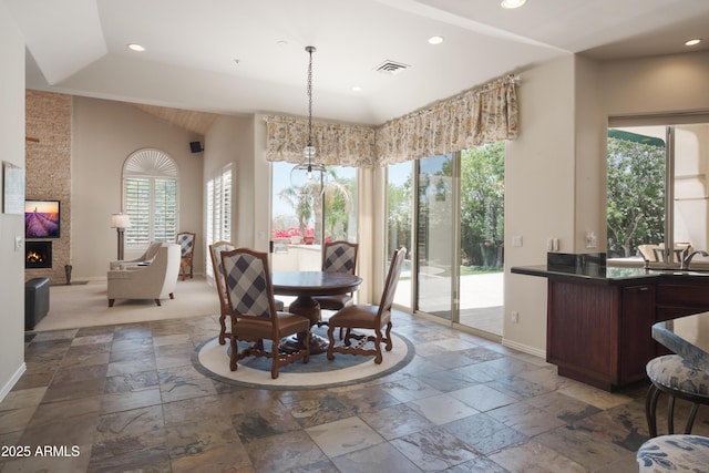 dining room with baseboards, recessed lighting, and stone tile flooring