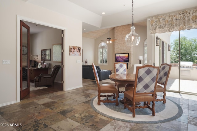 dining room with a ceiling fan, vaulted ceiling, baseboards, recessed lighting, and stone tile floors