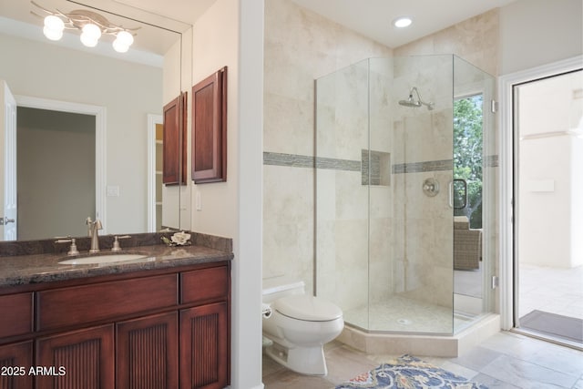 full bath with vanity, toilet, and a shower stall