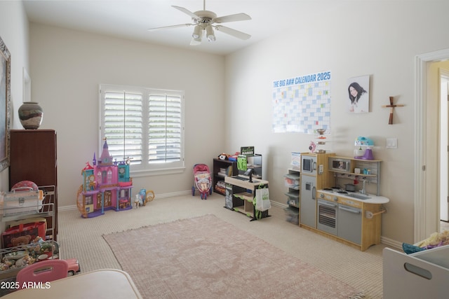 rec room with carpet flooring, ceiling fan, and baseboards