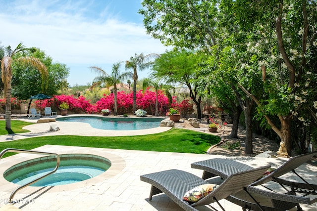 outdoor pool with a patio, an in ground hot tub, and a yard