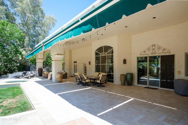 exterior space with a patio area and stucco siding