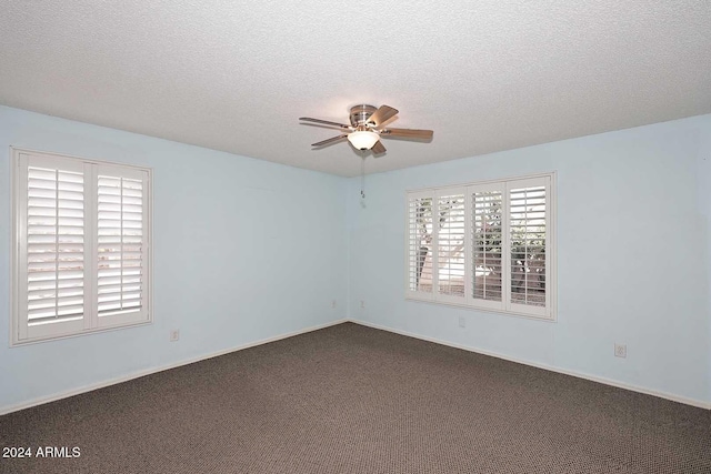 unfurnished room featuring ceiling fan, carpet floors, and a textured ceiling