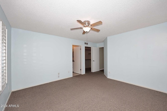 unfurnished room featuring ceiling fan, carpet, and a textured ceiling