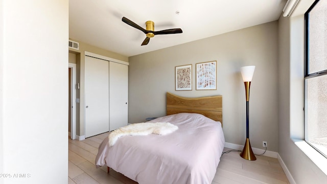 25555 N Windy Walk Dr Unit 64, Scottsdale, AZ 85255 - bedroom featuring a closet, light wood-type flooring, and a ceiling fan