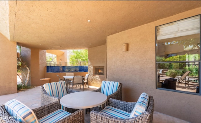 25555 N Windy Walk Dr Unit 64, Scottsdale, AZ 85255 - view of patio with outdoor dining area and a warm lit fireplace