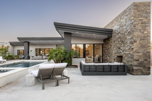 exterior space featuring an outdoor living space, pool water feature, and a patio area