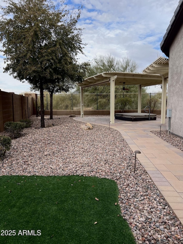 view of yard featuring a patio, ceiling fan, and a pergola