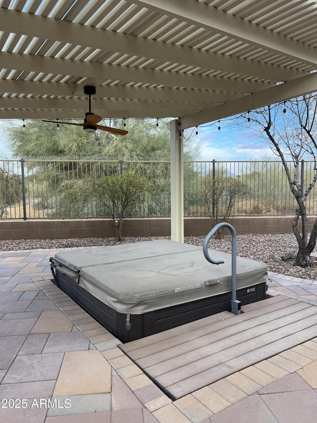 view of patio with a covered hot tub and ceiling fan