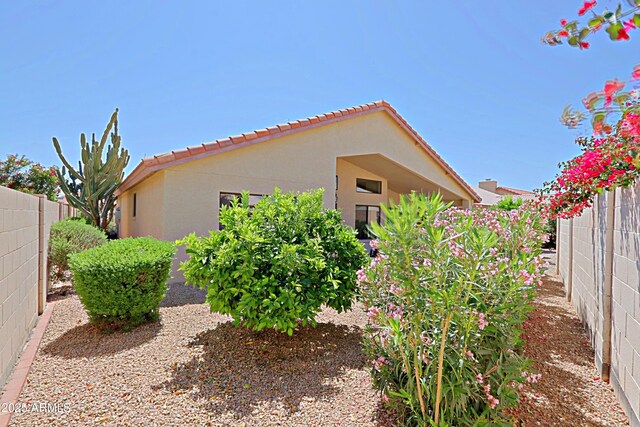 3928 N 151st Ave, Goodyear, AZ 85395 - view of property exterior featuring stucco siding, fence, and a tiled roof