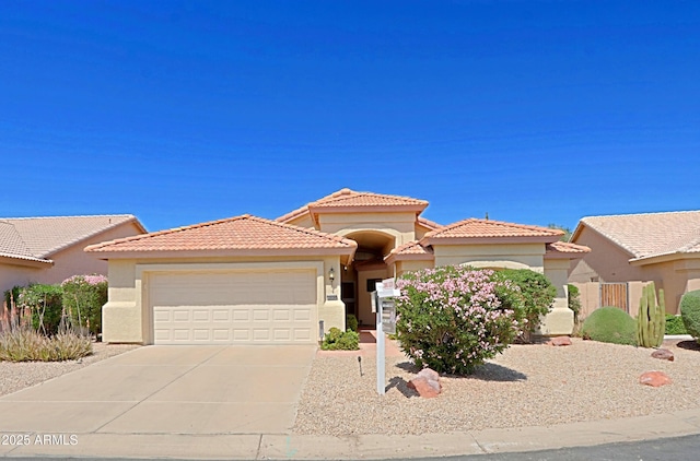 3928 N 151st Ave, Goodyear, AZ 85395 - view of front of house with a tile roof, an attached garage, driveway, and stucco siding