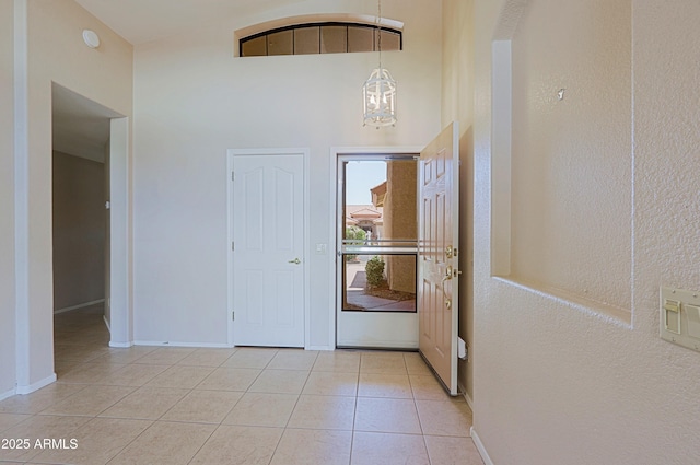 3928 N 151st Ave, Goodyear, AZ 85395 - entryway featuring light tile patterned floors, baseboards, and a chandelier