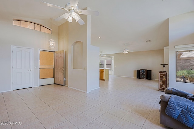 3928 N 151st Ave, Goodyear, AZ 85395 - living area featuring light tile patterned floors, baseboards, a ceiling fan, and high vaulted ceiling