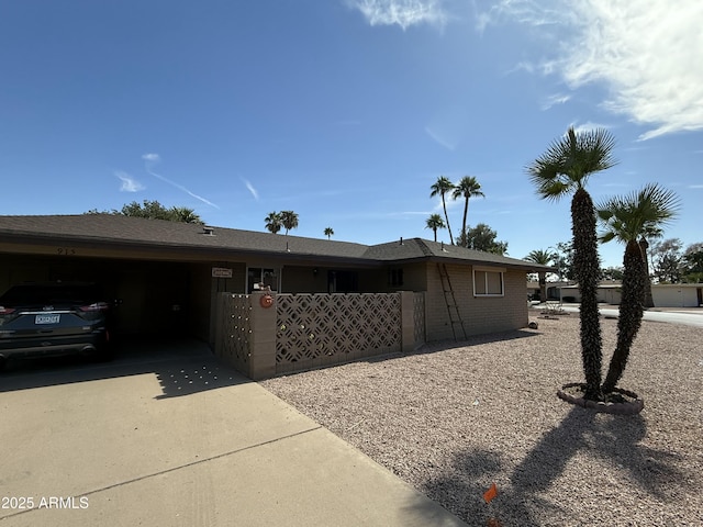 view of home's exterior featuring a garage, concrete driveway, and brick siding