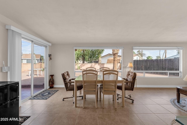 dining room featuring tile patterned flooring and baseboards