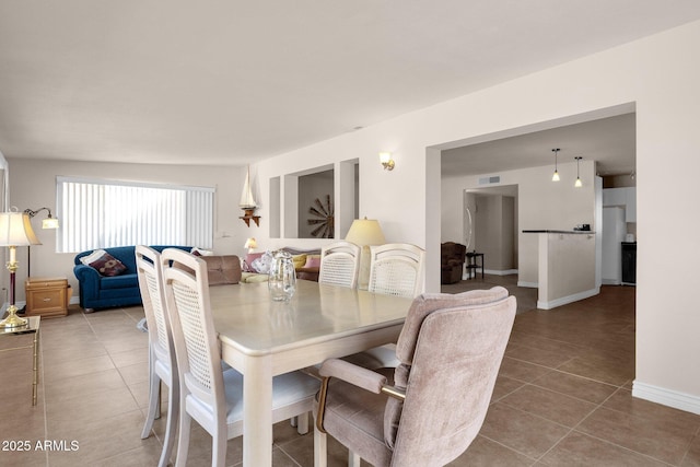 dining room with light tile patterned floors, baseboards, and visible vents