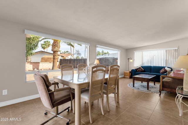 dining room with a healthy amount of sunlight and light tile patterned floors