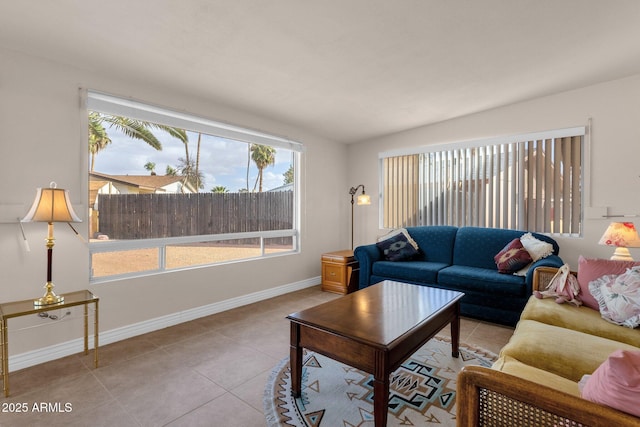 living room with tile patterned flooring and baseboards