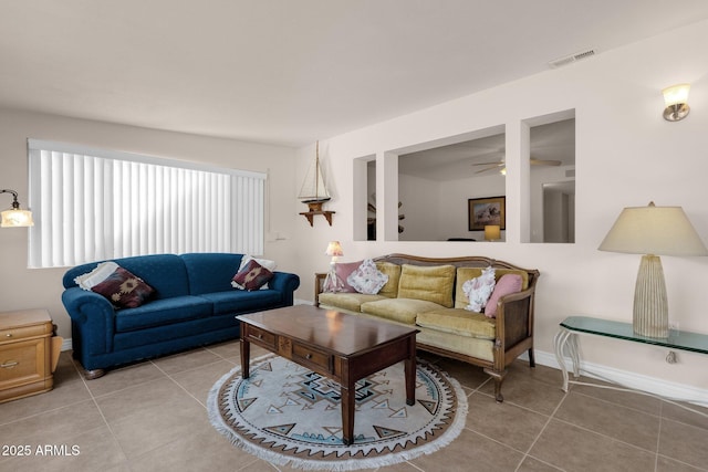 living room featuring visible vents, baseboards, and light tile patterned flooring