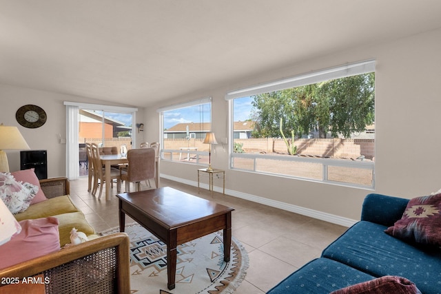 tiled living area featuring baseboards and a wealth of natural light