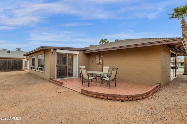 back of property featuring a patio and fence