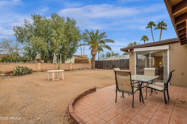 view of patio featuring a fenced backyard and outdoor dining area