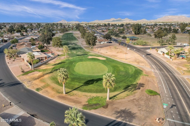 aerial view featuring view of golf course and a mountain view