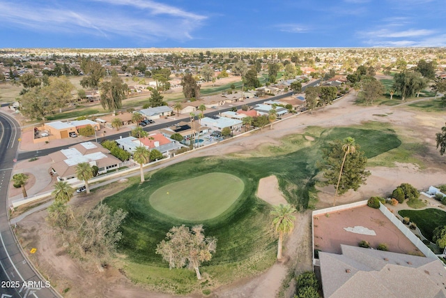 drone / aerial view featuring view of golf course and a residential view