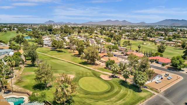 aerial view featuring view of golf course, a residential view, and a mountain view